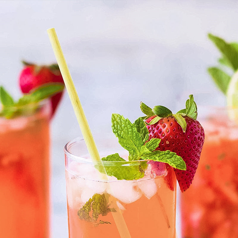 Natural Wheat Reusable Straw in a refreshing drink with strawberries and mint.