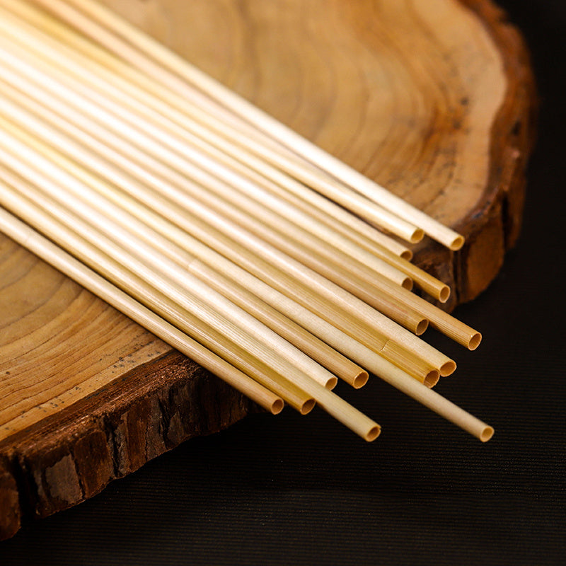 Natural Wheat Reusable Straw on a wooden surface, showcasing eco-friendly sipping alternatives to plastic.
